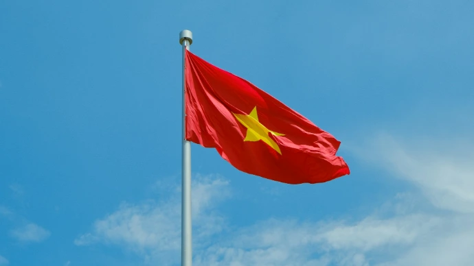 A chinese flag flying high in the sky